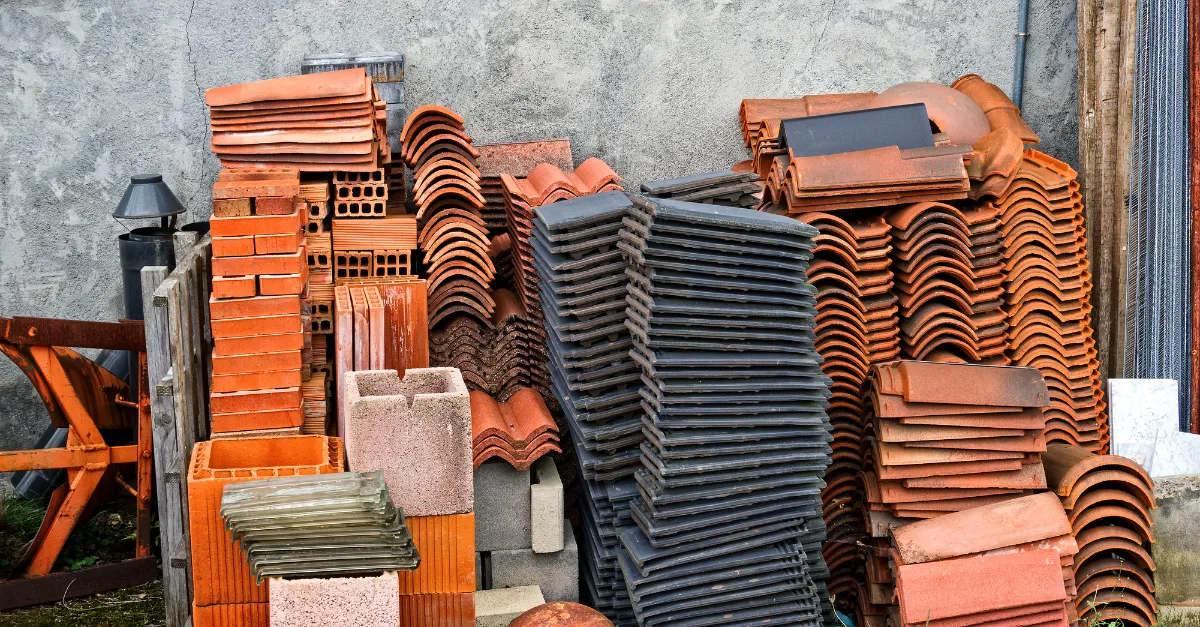 Reclaimed roof tiles, bricks and blocks stacked for reuse